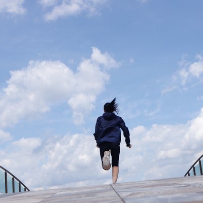 Rear view of woman running outdoors