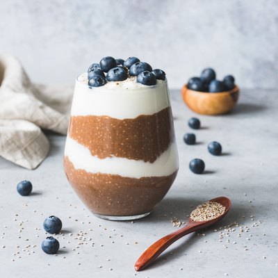 A glass of Chocolate Chia Seed Pudding with blueberries on top