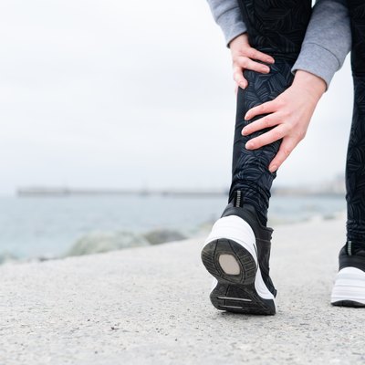 Leg muscle cramp calf sport injury outdoors exercise.