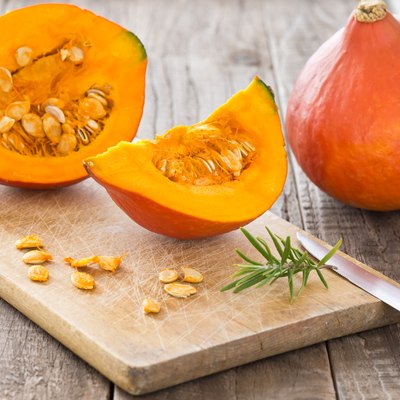 Sliced hokkaido pumpkin on a wooden board