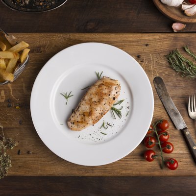 Grilled chicken breast and vegetables on the plate