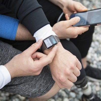 People preparing smart watch, checking fitness app on smart phone