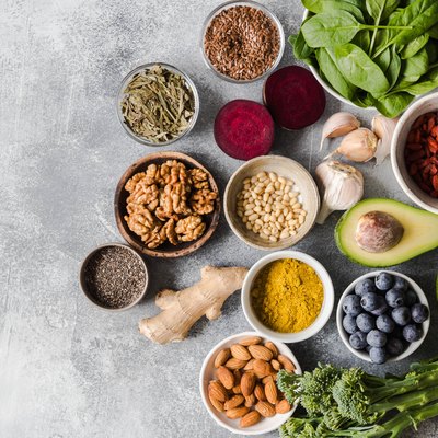 Healthy clean food - vegetables, fruits, nuts, superfoods on a gray background. Healthy eating concept. Top view.