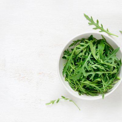 Arugula in a white bowl