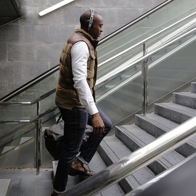 Side view of man climbing steps at subway station