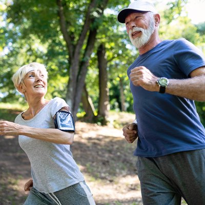 Older woman and man running outside