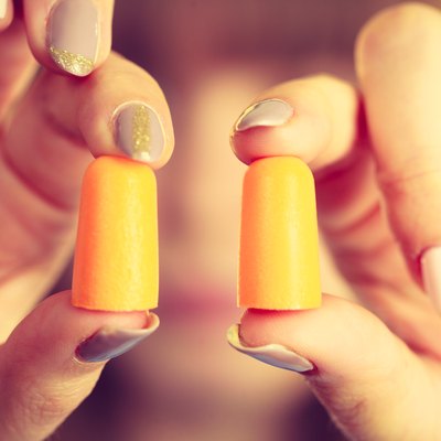 Woman holding protective earplugs