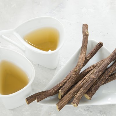 Licorice tea and roots on white background