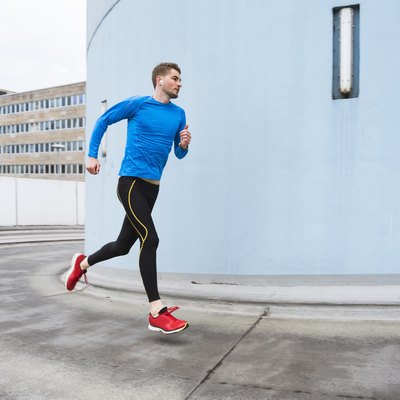 Young man doing a HIIT running workout in the city
