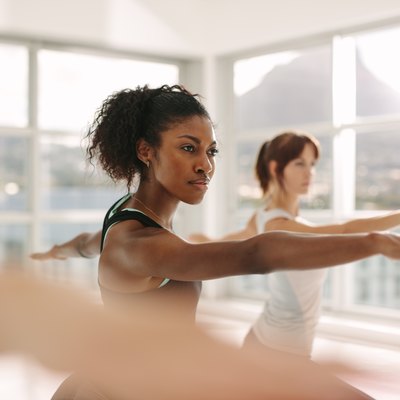 Women doing stretching and yoga workout at gym