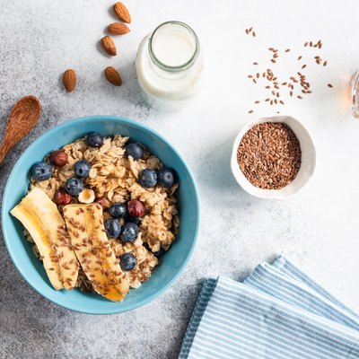 Oatmeal porridge in bowl with flax seeds and fruits
