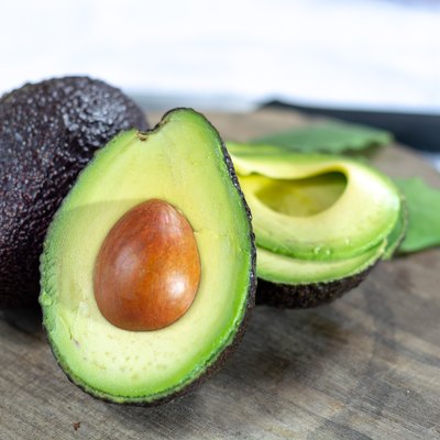 Two ripe raw hass avocados close up