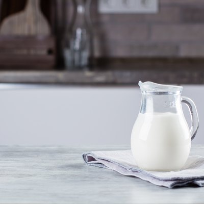 Jug of milk on concrete table background on the kitchen. Dairy Product. Copy space