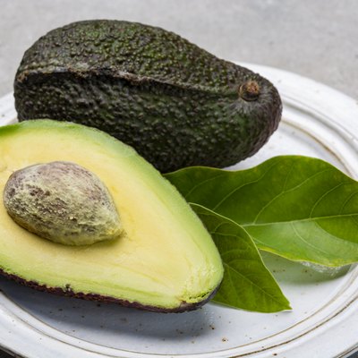 New harvest of fresh ripe hass avocado, cut in half