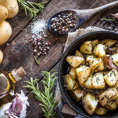 Roasted potatoes on wooden kitchen table