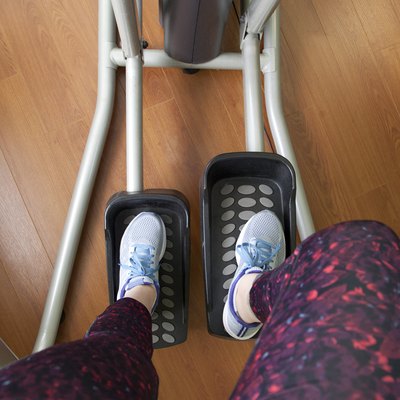 Sneakers and workout clothes on legs using the elliptical