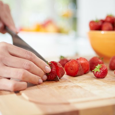 Close Up Of Woman Preparing Fruit Salad