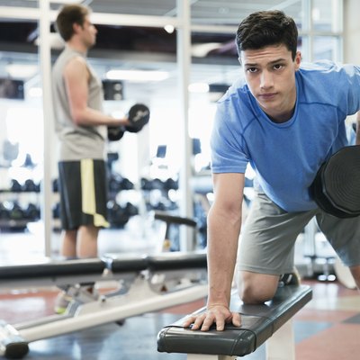 Man lifting weights in fitness center