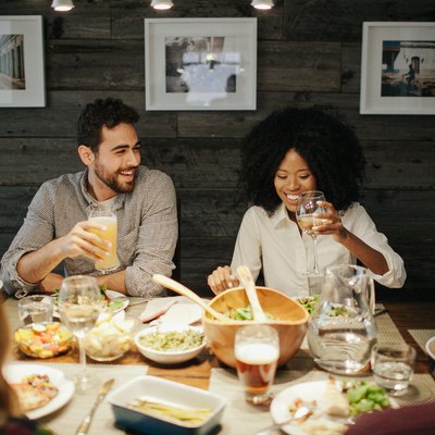 A young couple at a dinner party.
