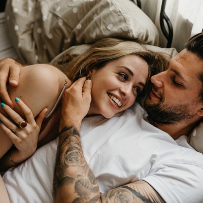 Couple lying in bed together