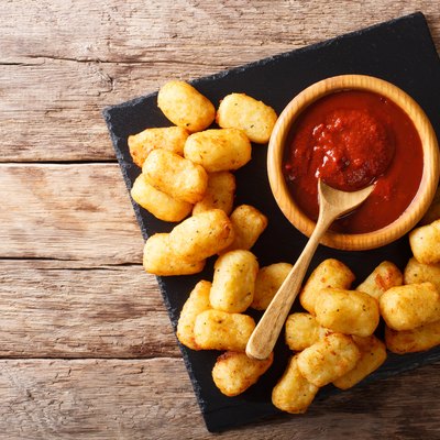 Deep-fried Potato Tater Tots and ketchup close-up. horizontal top view