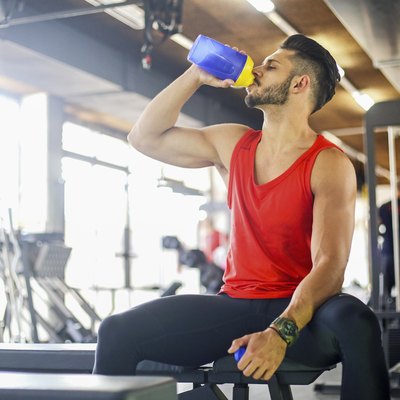 Young muscular man drinking a protein drink