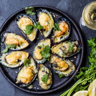 Seafood. Baked mussels with cheese and lemon in shells
