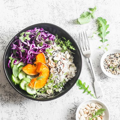 Wild rice, roasted pumpkin, red cabbage buddha bowl. Vegetarian food concept. On a light background, top view