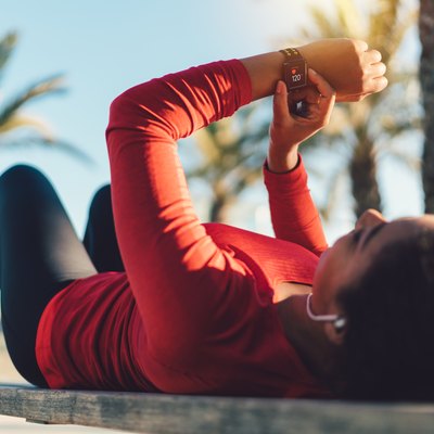 Sportswoman checking pulse on smartwatch