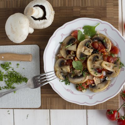 Fried mushrooms and tomatoes with coriander