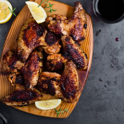 Roast chicken wings on cutting board