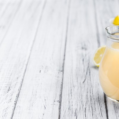 Wooden table with Lemon Juice (selective focus)