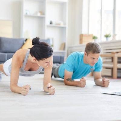 Man and woman working out in their hotel room