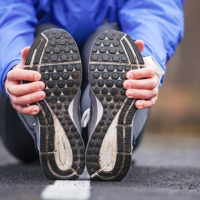 Cropped shot of a young runner stretching after workout.