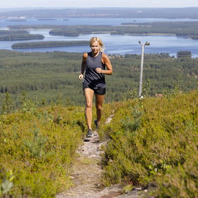 Woman running on track up hill