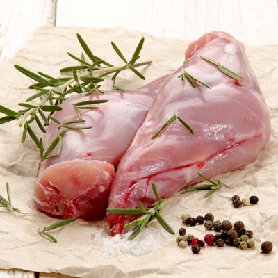 raw rabbit leg on brown paper
