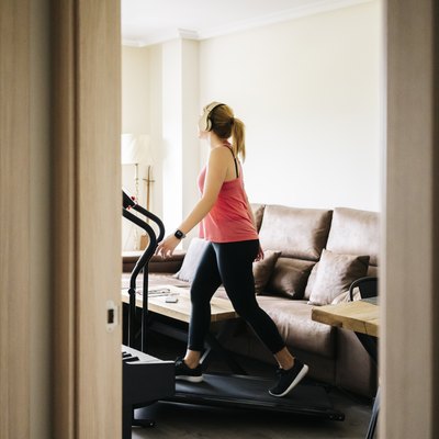 woman exercising on a treadmill at home