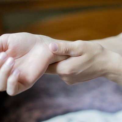 close up hand touch arm feeling pain f