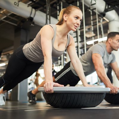 Couple Doing Balance Exercises in Gym
