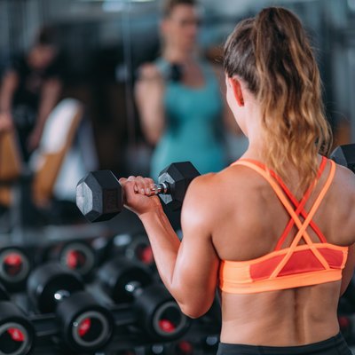 Friends Exercising with Weights in the Gym