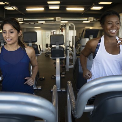 Women using treadmills in gym