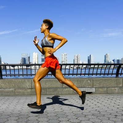 Mixed race woman running at waterfront