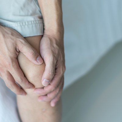 Knee pain disease concept. Hands on leg as hurt from Arthritis, gout or infections.