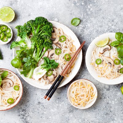 Vegetarian traditional Vietnamese soup Pho bo with herbs, rice noodles, broccolini, bok choy, bean sprouts, mushrooms. Vietnam national dish. Asian food concept.