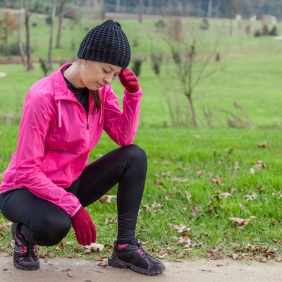 Young female athlete feeling lightheaded or with headache