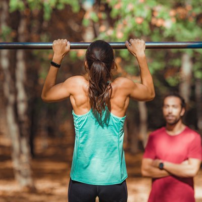 Woman doing pull-ups in the park
