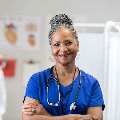 Portrait of confident senior female doctor in scrubs