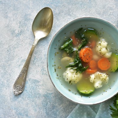 Vegetable soup with spinach, zucchini, carrot and cauliflower