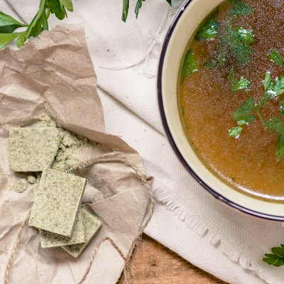Bouillon cubes next to a bowl of broth