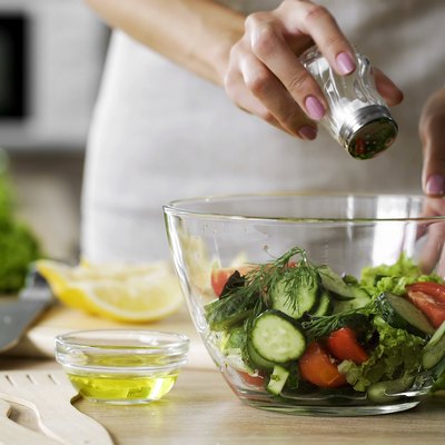Adding salt tovegetable salad glass bowl for low sodium diet